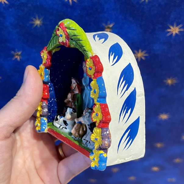 Peruvian nativity scene with large flower garland